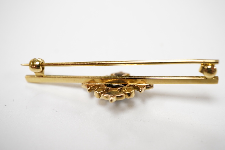 An Edwardian opal triplet, seed pearl and diamond bar brooch, early 20th century and later, of foliate design, centring on a claw-set oval opal triplet, within a foliate border set with split seed pearls and cushion-shap